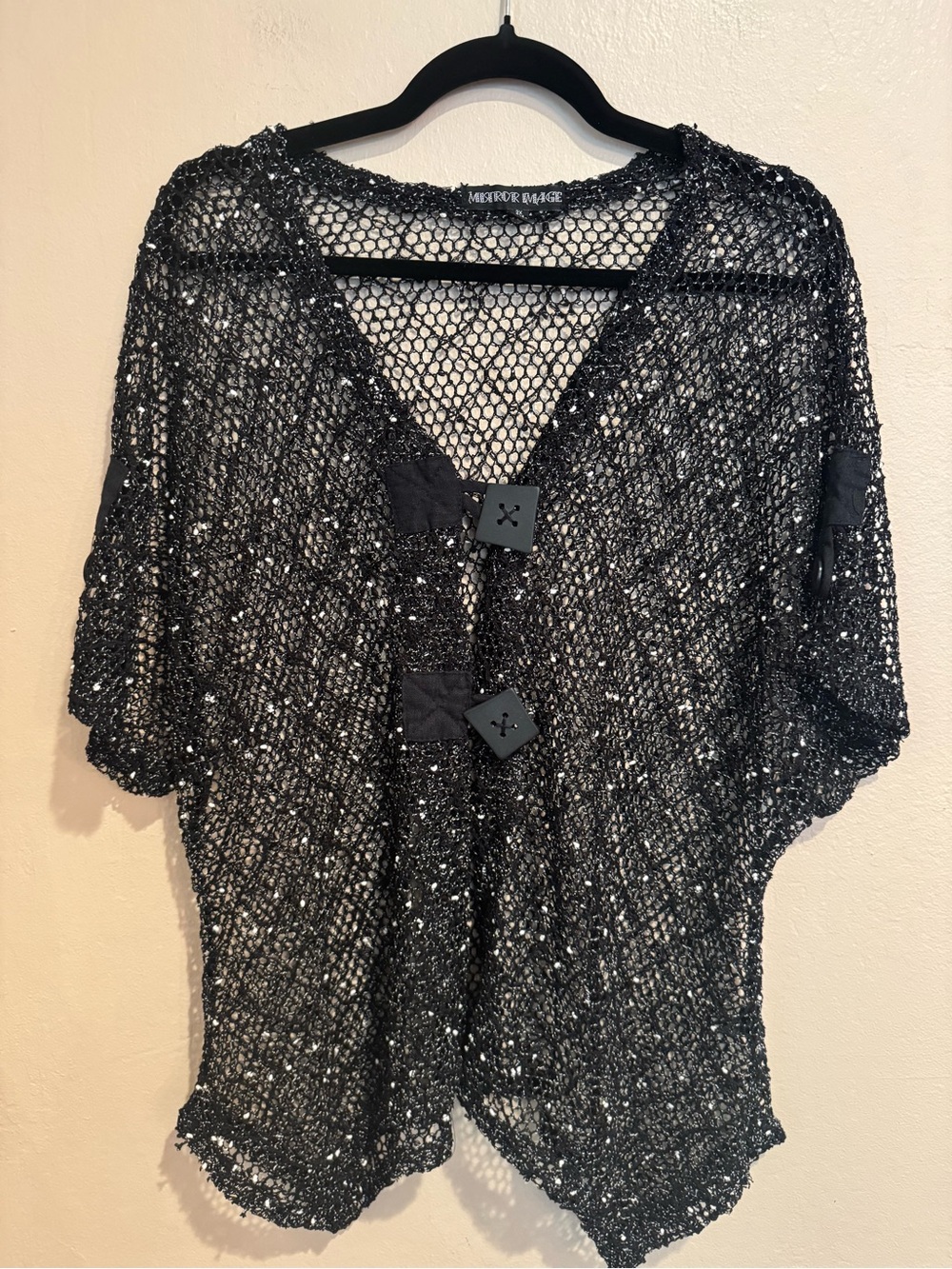 Black Open-Knit Cardigan with White Confetti Like Speckles and Zig-Zag Hem Line